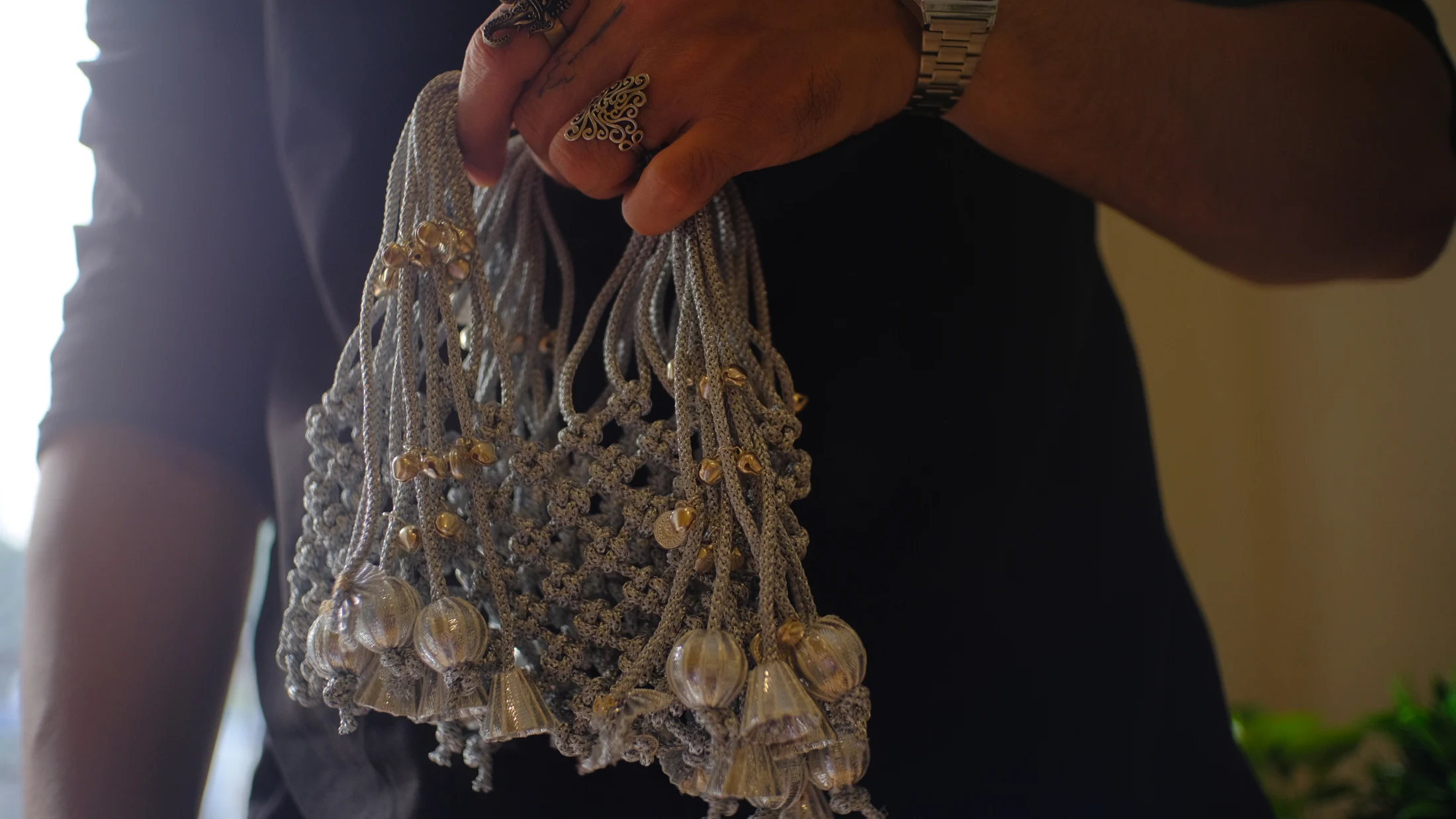 Silver mesh and pearl bag carried by its chain